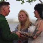 Couple exchanging vows in outdoor wedding ceremony