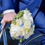Wedding couple holding floral bouquet