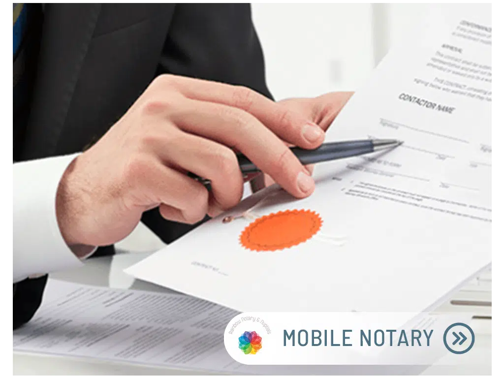 Person signing document with mobile notary stamp.
