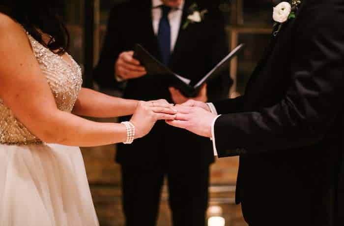 Couple exchanging rings during wedding ceremony