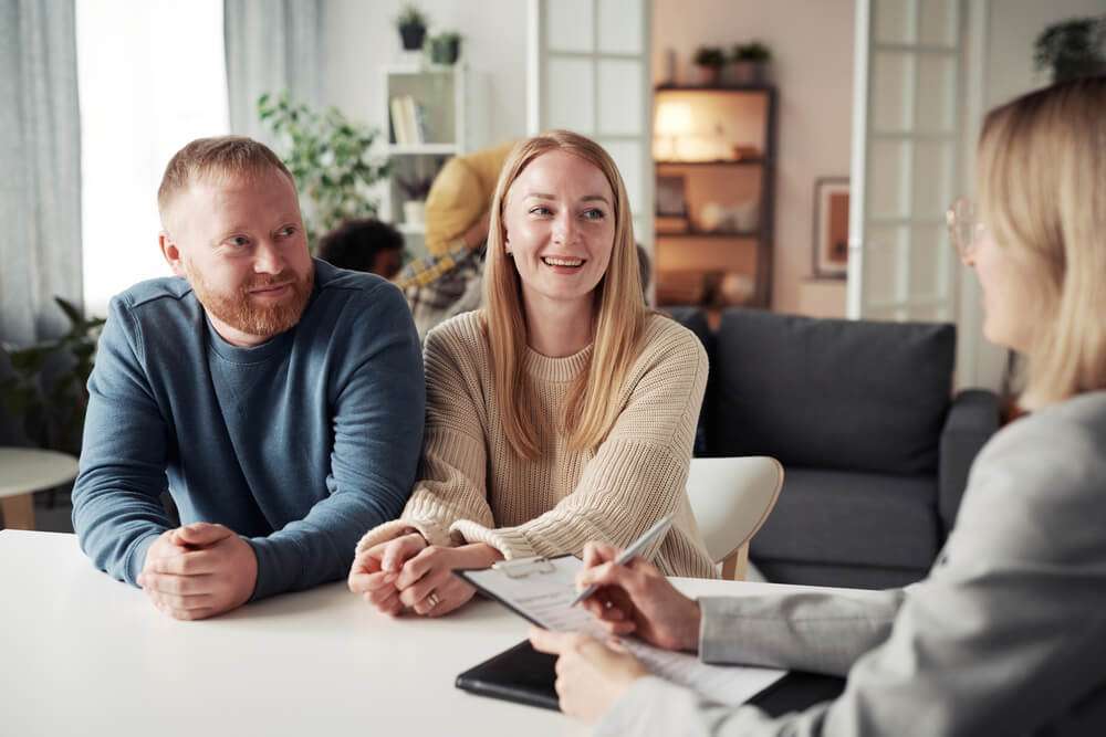 Foster couple discussing with social worker