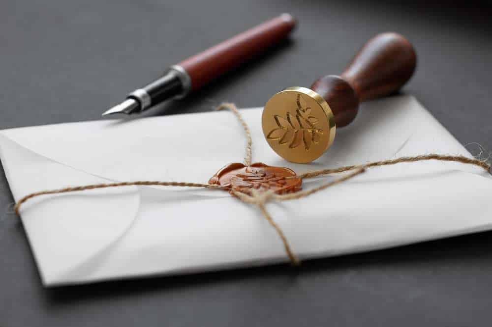 Sealed envelope with wax stamp and fountain pen.