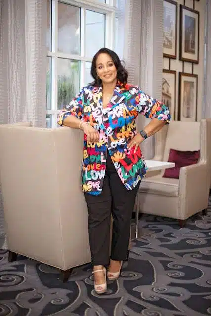 Woman smiling in colorful blouse indoors