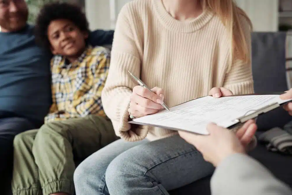 Woman signing adoption contract with social worker