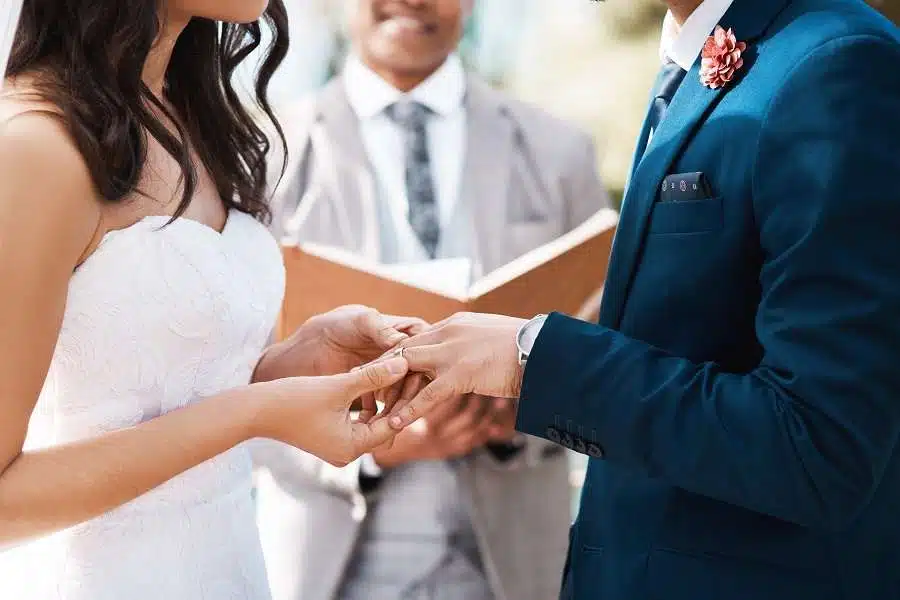 Wedding officiant performing ceremony for happy couple