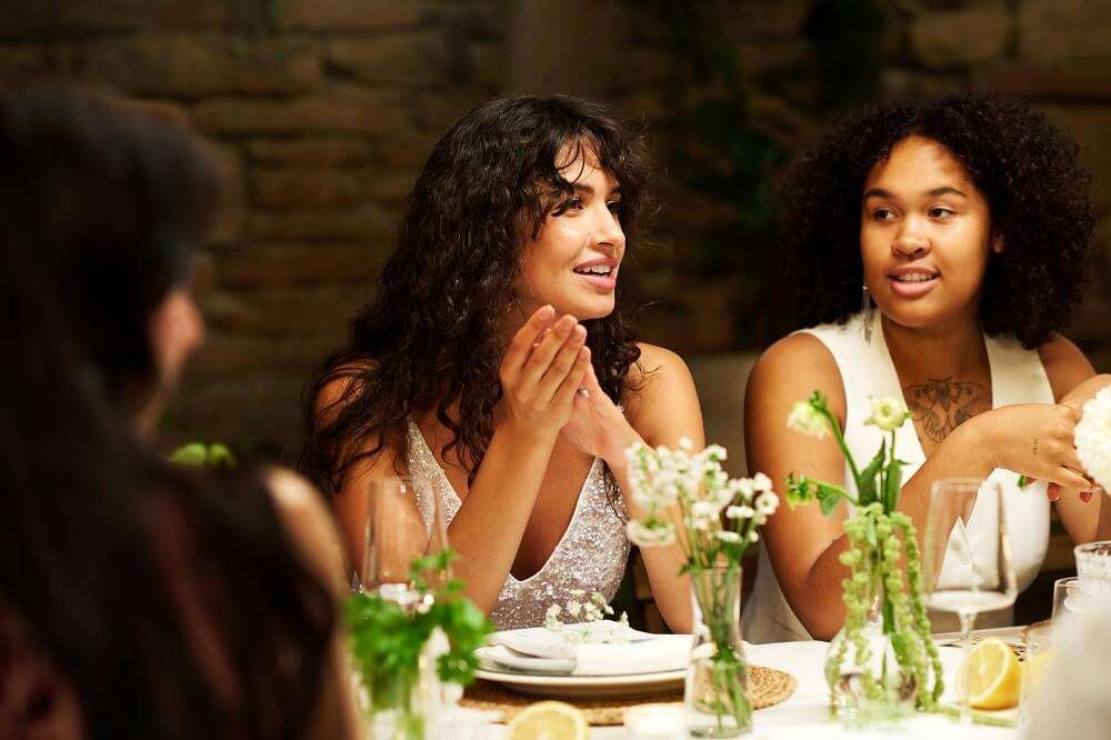 Young multicultural lesbian couple in white attire