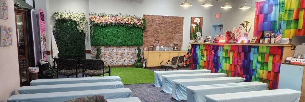 On Valentine's Day and any day at Jacksonville's Rainbow Wedding Chapel, 'love is love' 6 Colorful event space with seating and floral decor.