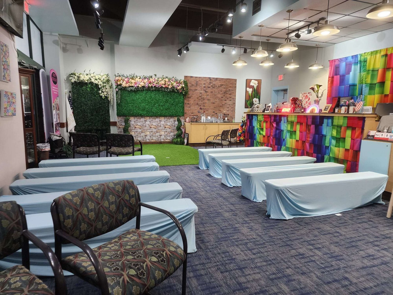 Colorful event space with seating and floral decor.
